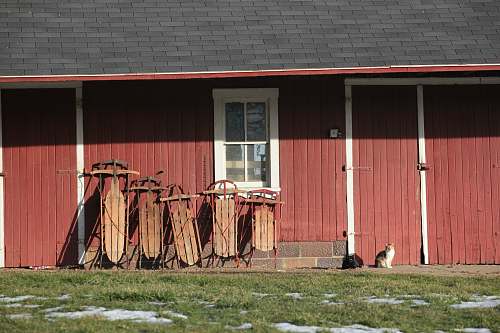 dalton five brown wooden snow sled on red wall water tower